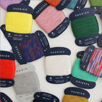 A collection of Daruma Fine Sashiko Thread cards in various colors displayed on a white background.