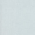 A close-up image of a blue cotton quilting fabric with a slight texture.