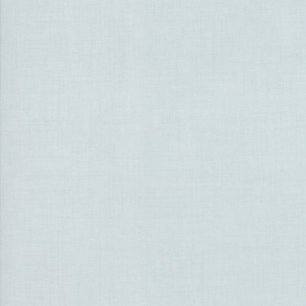 A close-up image of a blue cotton quilting fabric with a slight texture.
