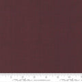 A solid burgundy colored blender Quilting fabric from the French General collection by Moda, with a ruler at the bottom showing the width in inches.