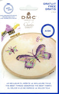 Packaging of DMC Cross-Stitch Fabric Aida 14 ct with an image of purple butterflies on sandstorm fabric, indicating it is part of the Charles Craft Collection and comes with a free pattern.
